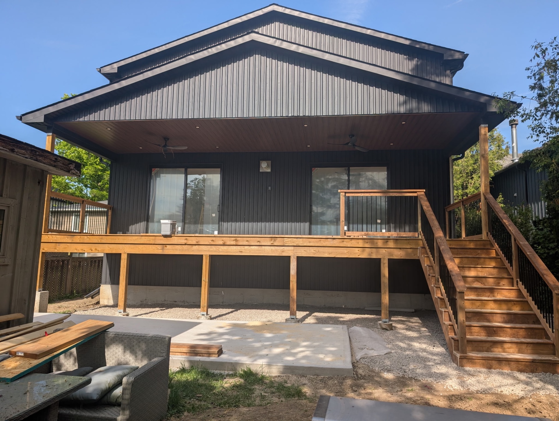 Dark vertical siding with new deck