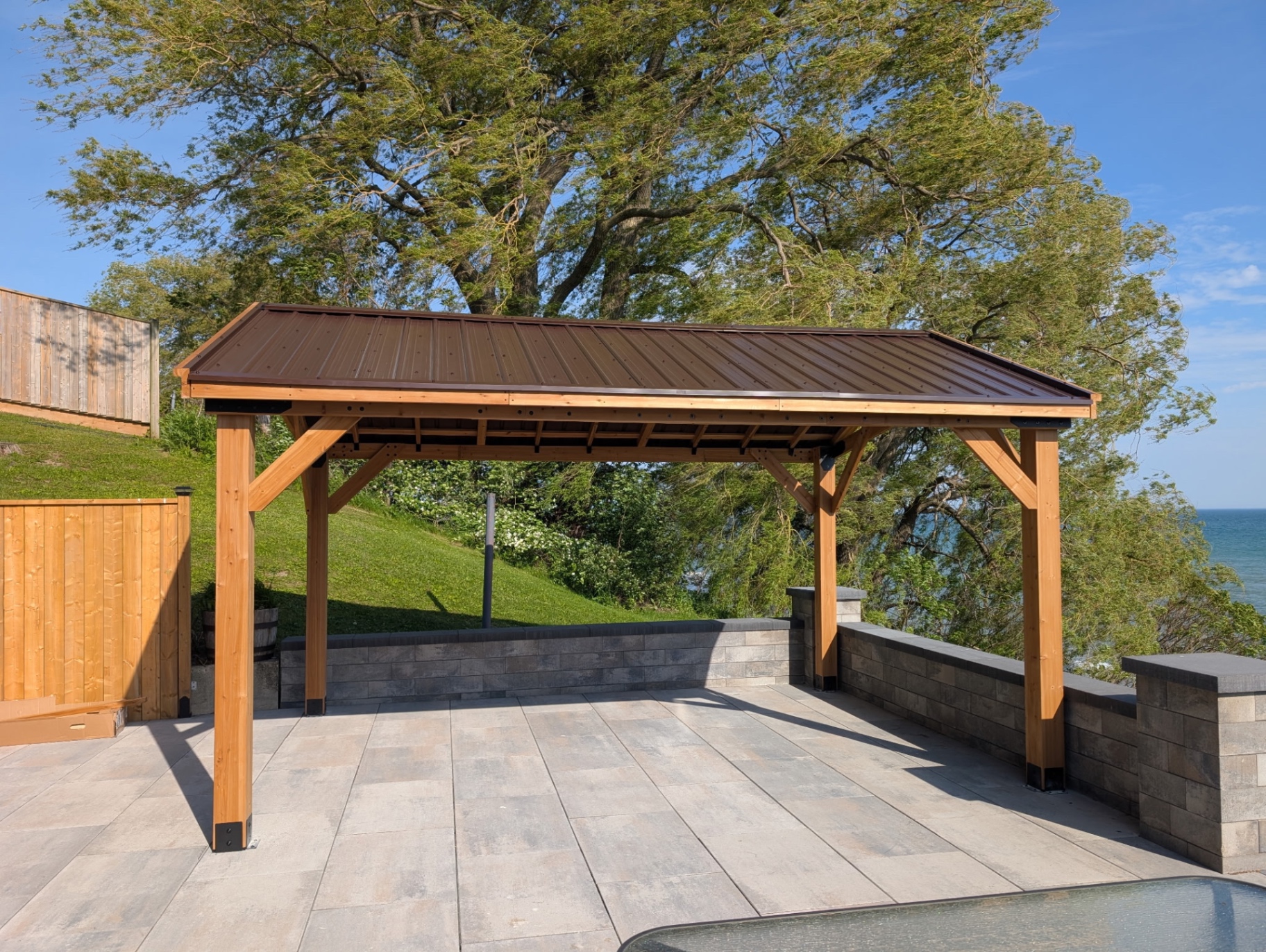 Metal-roof pavilion on stone patio