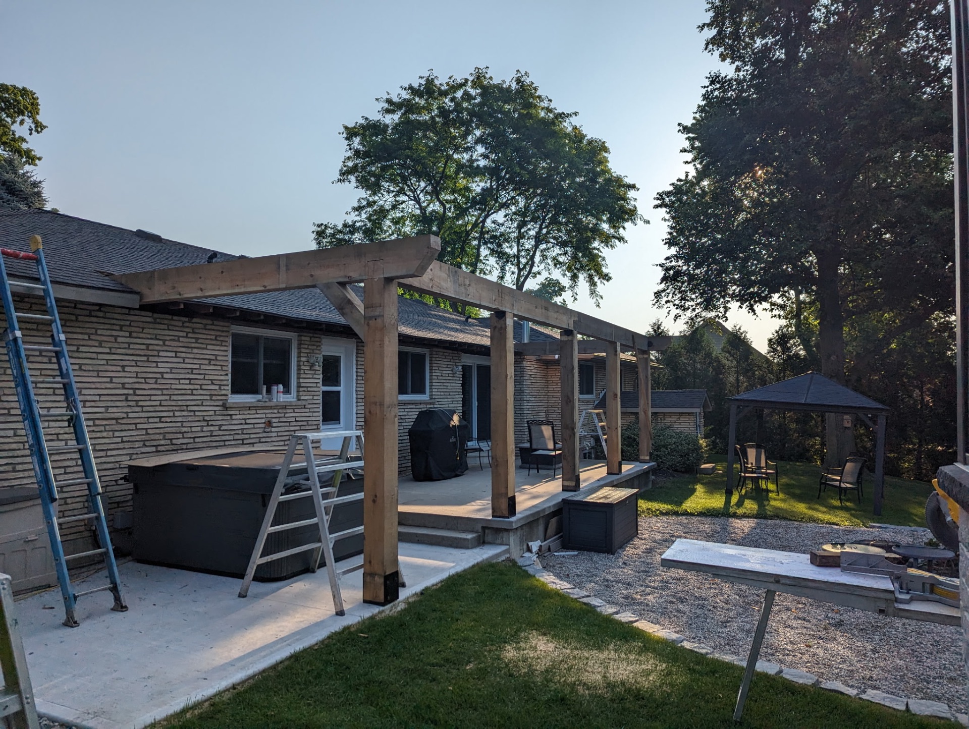 Pergola along brick home